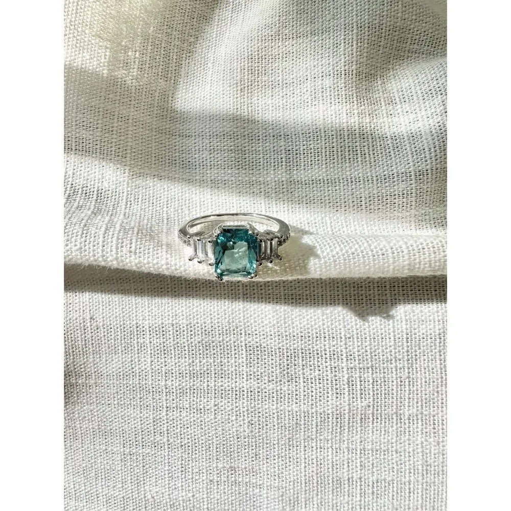 Light blue elongated radiant cut ring
